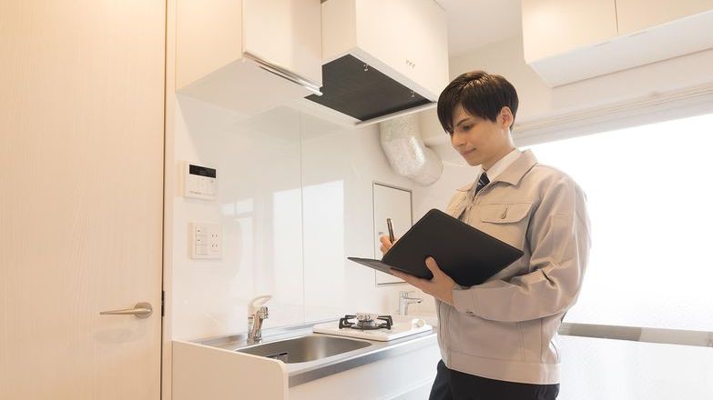 Inventory clerk making notes in kitchen