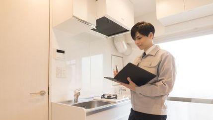 Inventory clerk making notes in kitchen