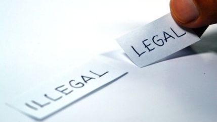 Illegal and legal written on small pieces of paper