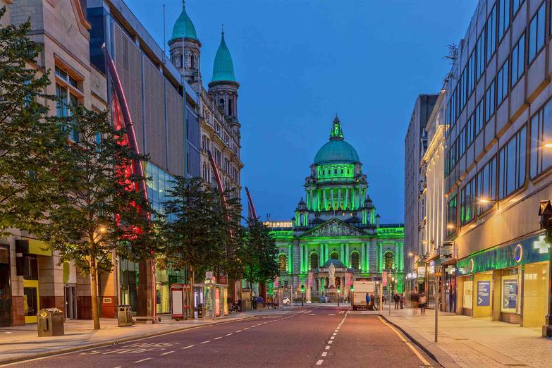 Belfast City Hall in Northern Ireland lit up green at night