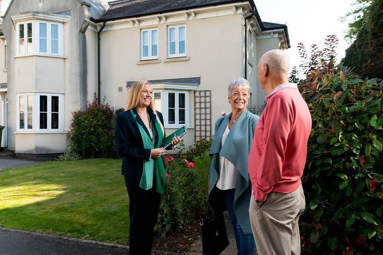 Estate agent speaking to elderly couple