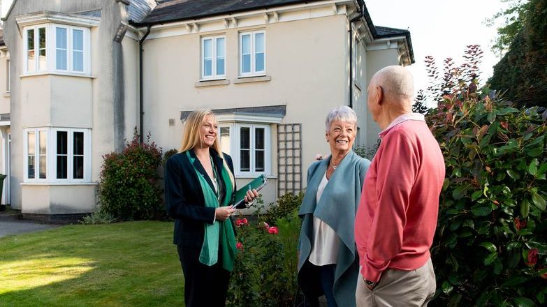 Retired couple at property with agent