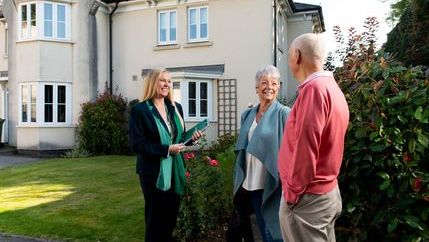 Retired couple at property with agent