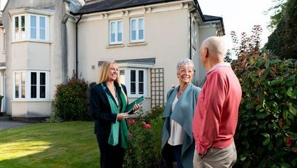 Retired couple at property with agent