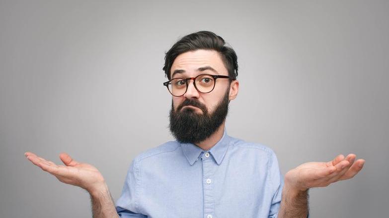 Unsure bearded man with glasses