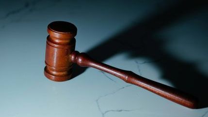 Auctioneer's gavel on a marble surface