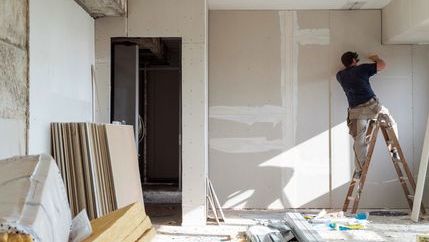 Man installing plaster boards