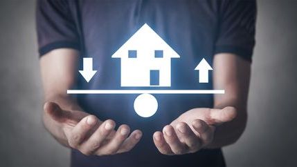 Illuminated house graphic with arrows points up and down