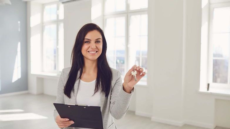 Agent in empty office holding a key