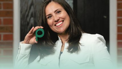 PML, Lady in white jacket holding Propertymark P.jpg