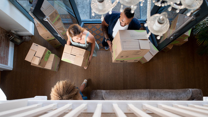 Family bringing boxes into the house