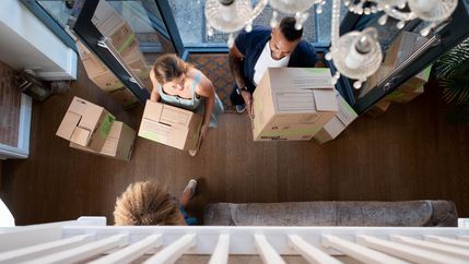 Family bringing boxes into the house
