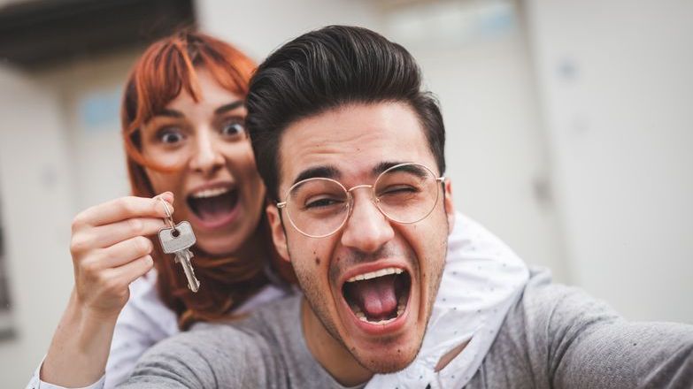 Couple celebrating with keys to new house