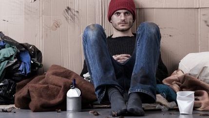 Homeless man wearing a red hat