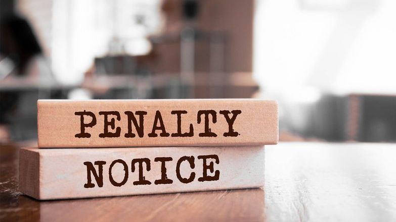 Penalty notice written on wooden blocks in office