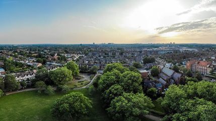 Aerial view of town with football pitch in foreground