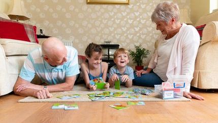 childen playing games with their grandparents