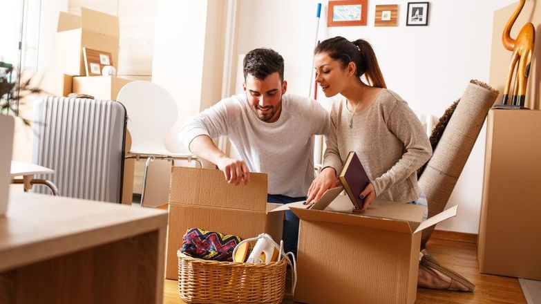 Couple packing boxes getting ready to move