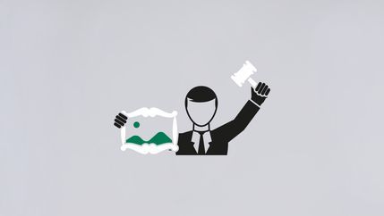Auctioneer holding painting graphic