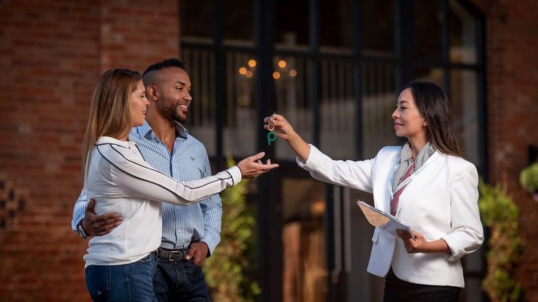 Couple taking a key of estate agent