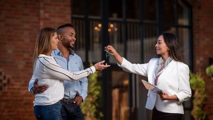 Couple taking a key of estate agent