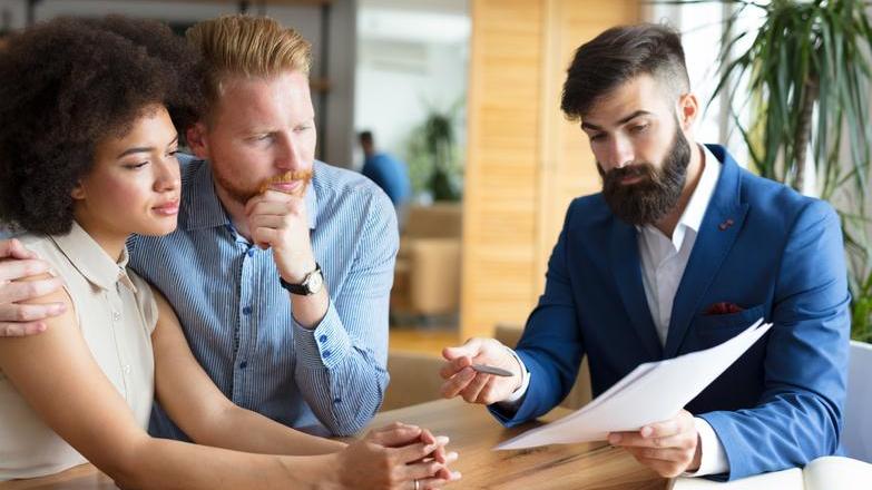 Agent talking to couple in branch