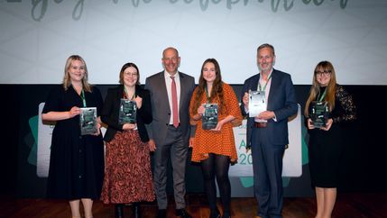 Five winners holding their awards alongside Phil Spencer 