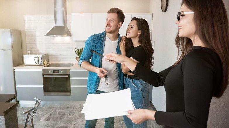 Agent showing a couple around a new build