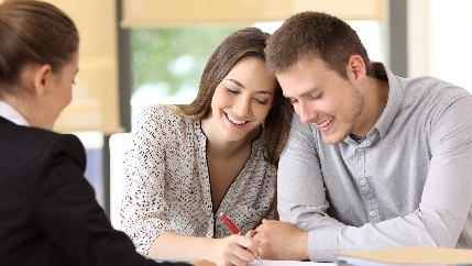 Happy couple signing contract.jpg