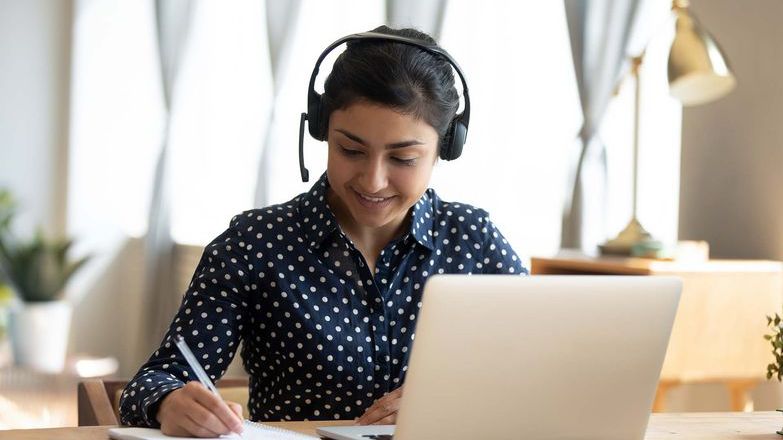Woman studying with headset on.jpg