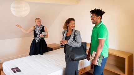 Mother and son viewing bedroom