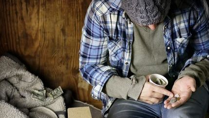 Homeless man counting change