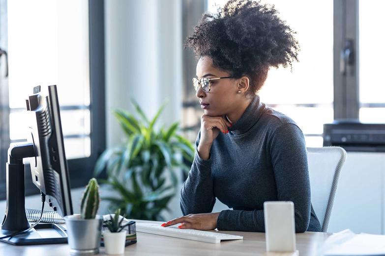 Woman with glasses looking at computer screen