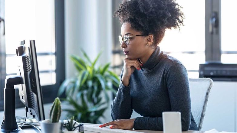 Woman with glasses looking at computer screen
