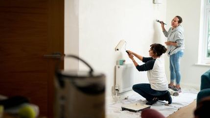 Couple painting wall