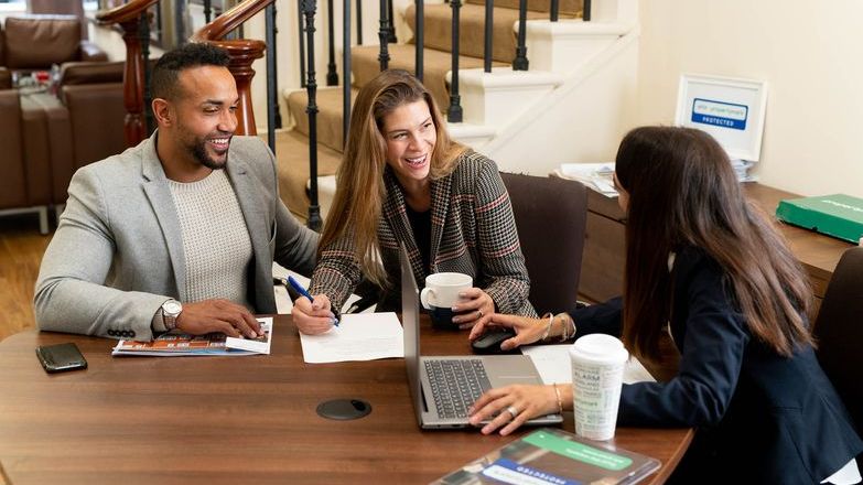 Couple signing contract with estate agent