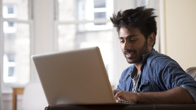 Man on laptop denim shirt.jpg