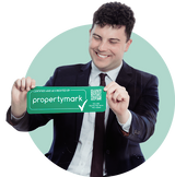 George in suit holding logo.png
