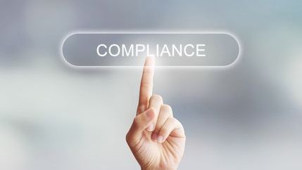 Compliance button being pressed by finger