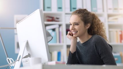 Woman studying at white computer.jpg