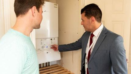 Agent showing a tenant the boiler