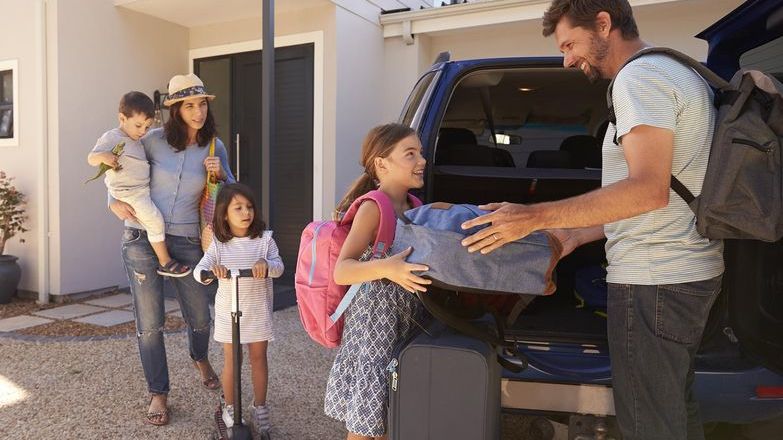 Family getting in the car for their holiday