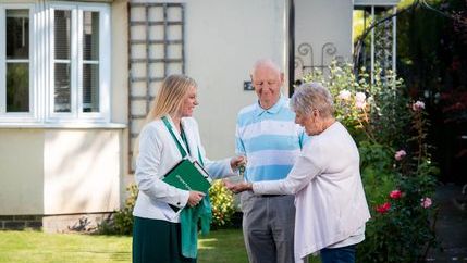 Retired couple getting key off estate agent