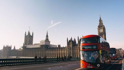 Houses of Parliament with Londong bus going across bridge