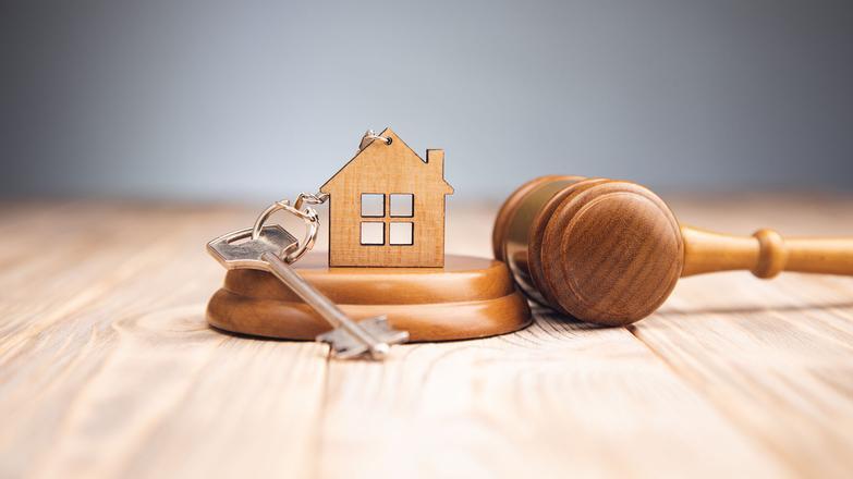 Gavel and key with house keyring