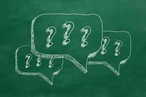 Question marks on chalkboard