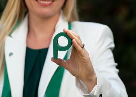 Blonde woman holding Propertymark letter P