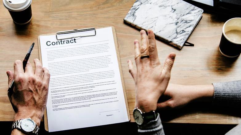 Contract on table waiting to be signed