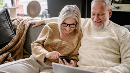 Mid-life couple on sofa (Canva).jpg