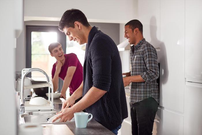 Housemates laughing in kitchen
